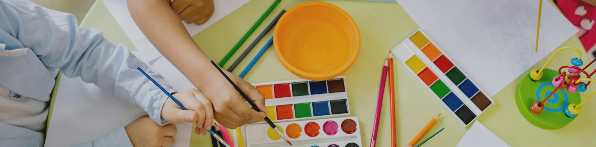 Children painting with colourful art materials
